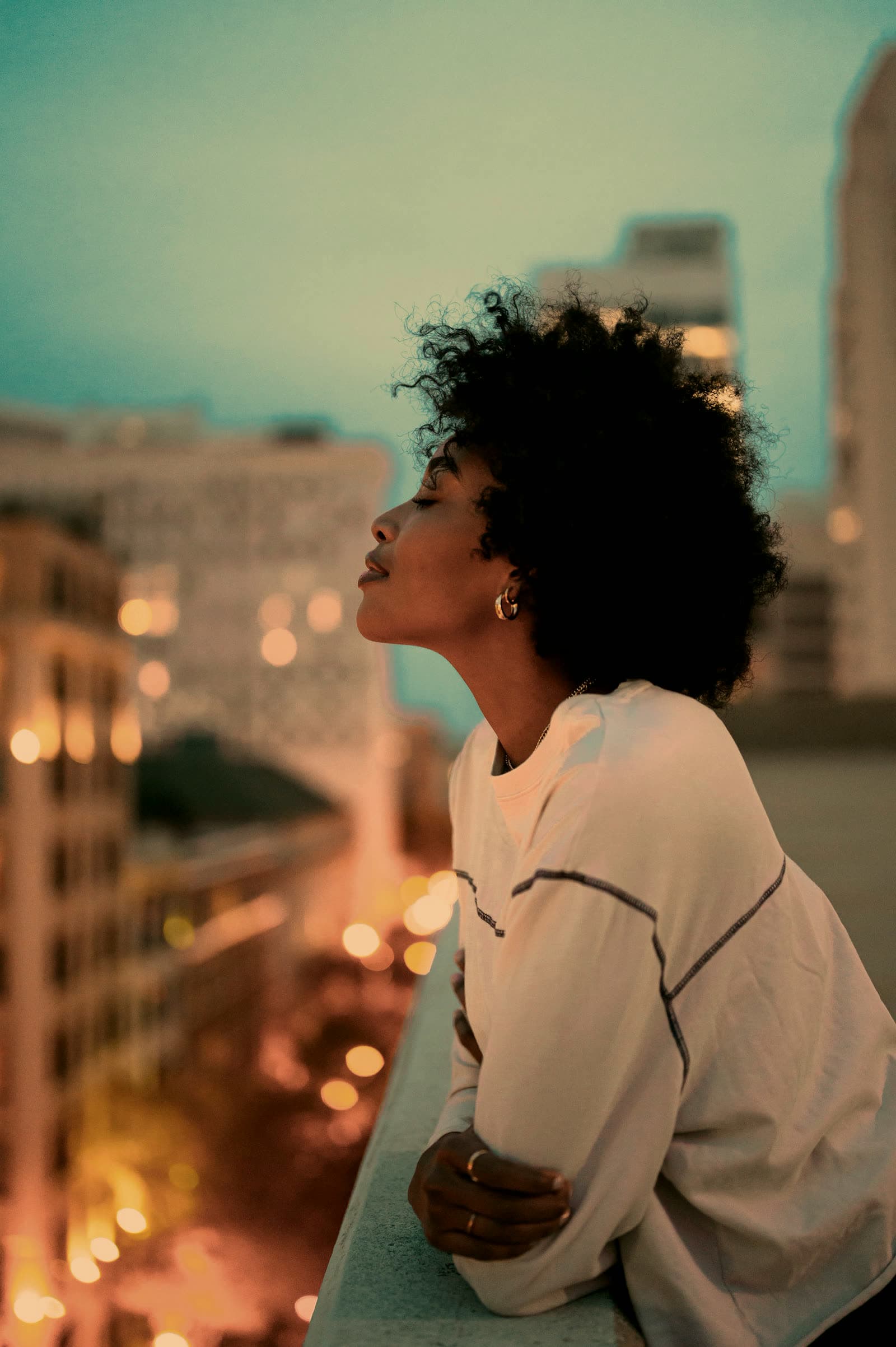 A woman with natural curls in warm evening light